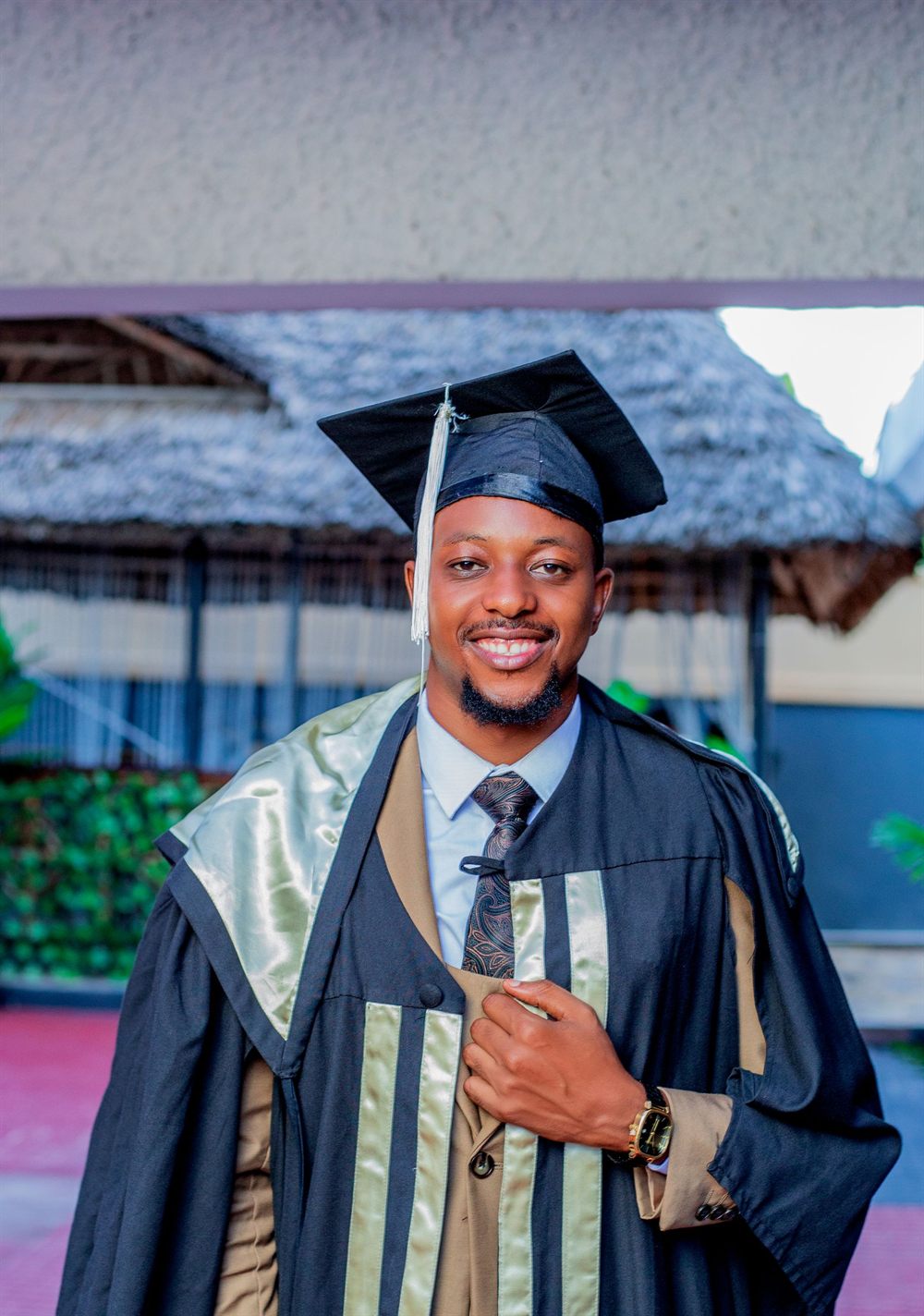 Nigerian graduate in cap and gown celebrating